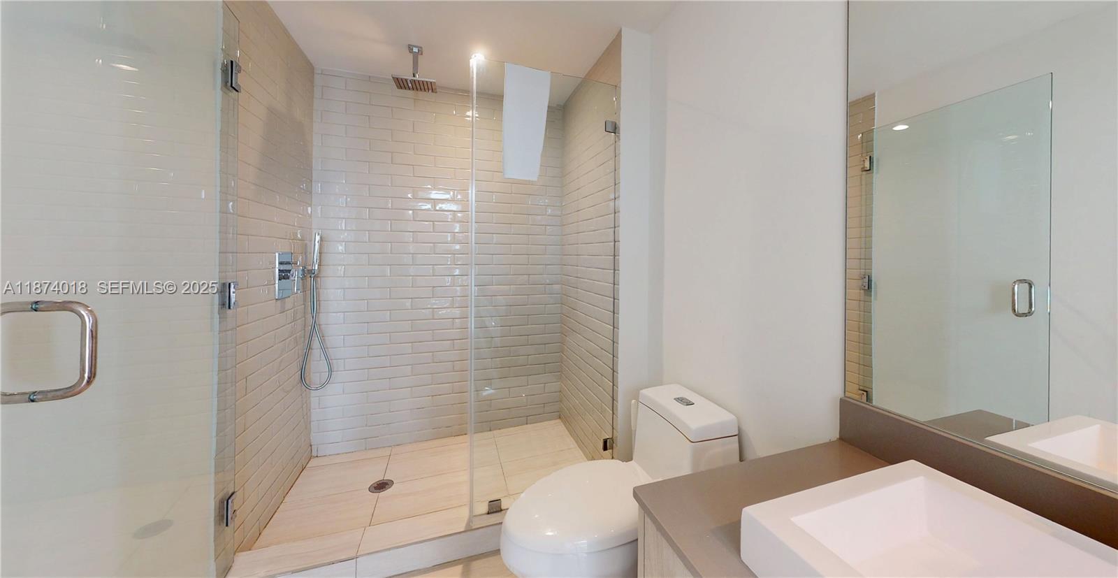 4010 South Ocean Drive, Unit R1004 Hollywood, FL 33019 - Photo 21 of 24 a bathroom with a toilet sink and shower