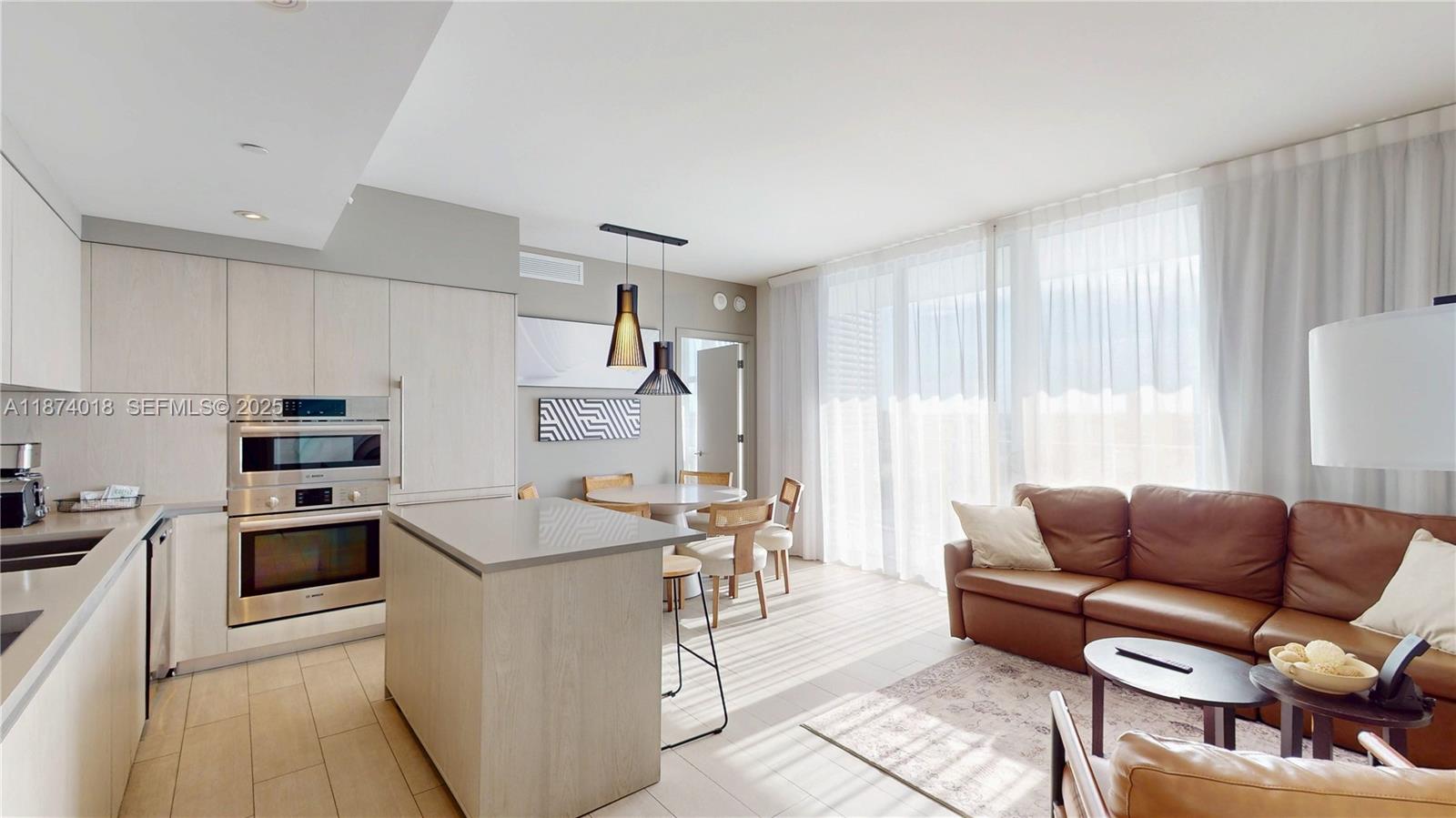 4010 South Ocean Drive, Unit R1004 Hollywood, FL 33019 - Photo 4 of 24 a kitchen with stainless steel appliances granite countertop a stove a sink and a refrigerator