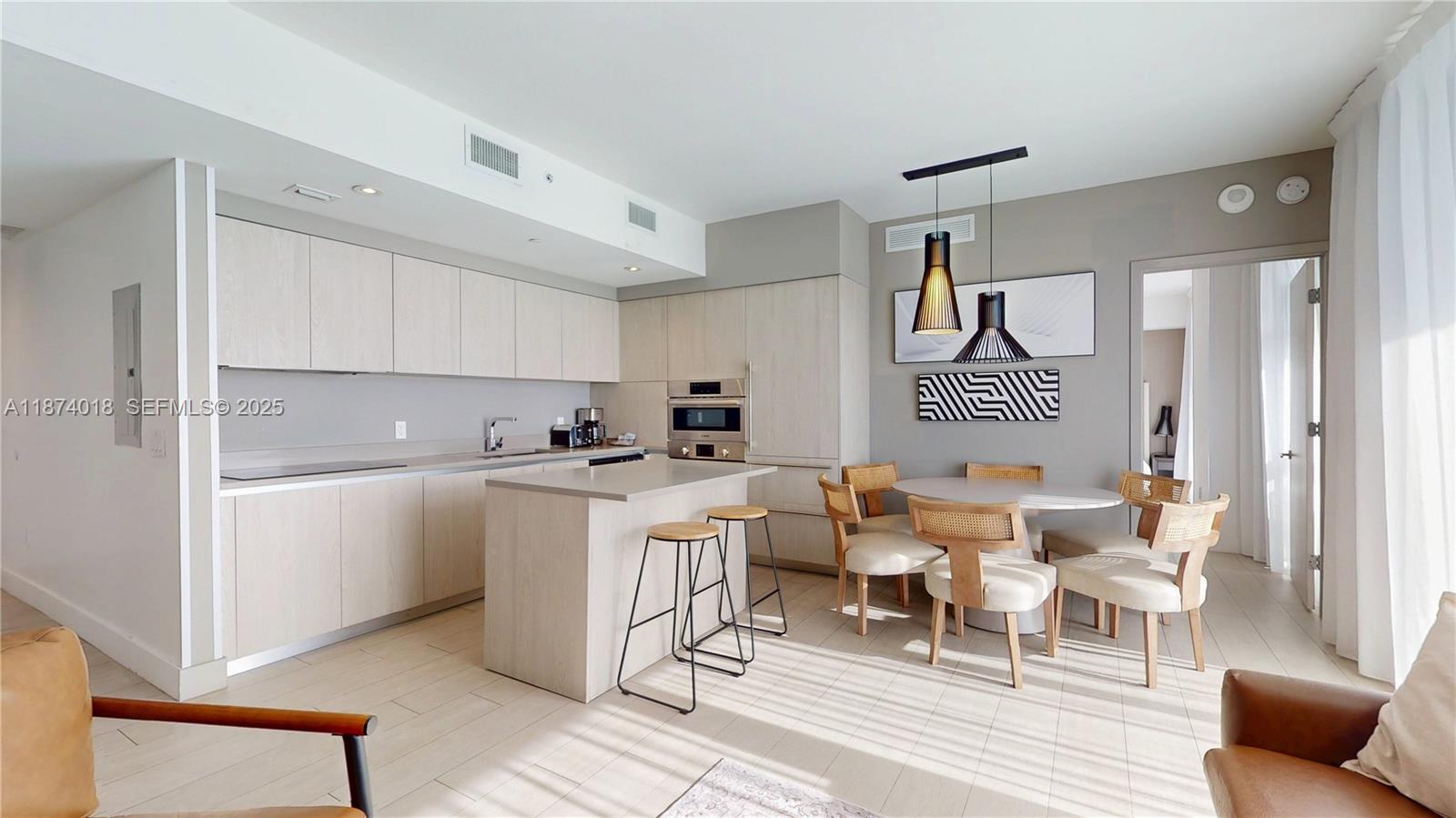 4010 South Ocean Drive, Unit R1004 Hollywood, FL 33019 - Photo 6 of 24 a living room with furniture and kitchen view