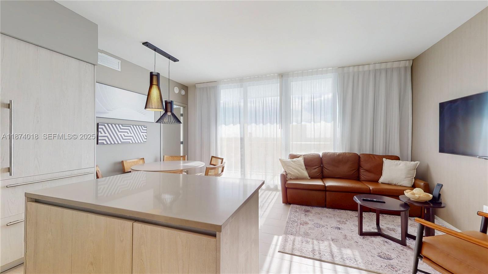 4010 South Ocean Drive, Unit R1004 Hollywood, FL 33019 - Photo 9 of 24 a living room with furniture and a couch