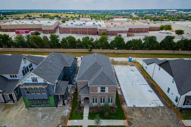 an aerial view of residential houses and city street