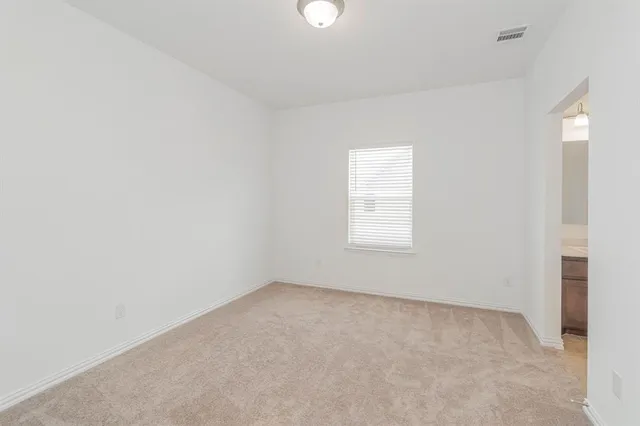 a view of an empty room and a window