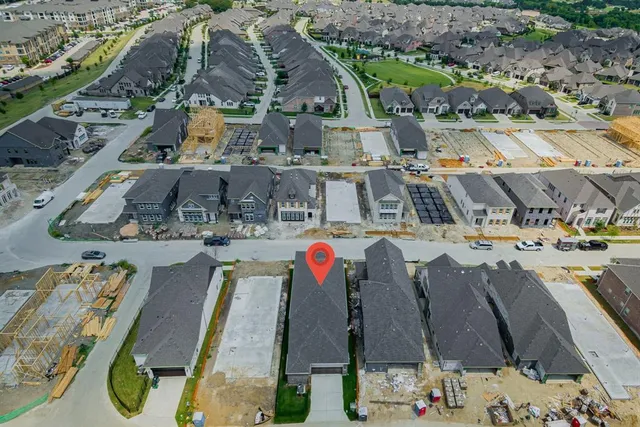 an aerial view of residential houses with outdoor space
