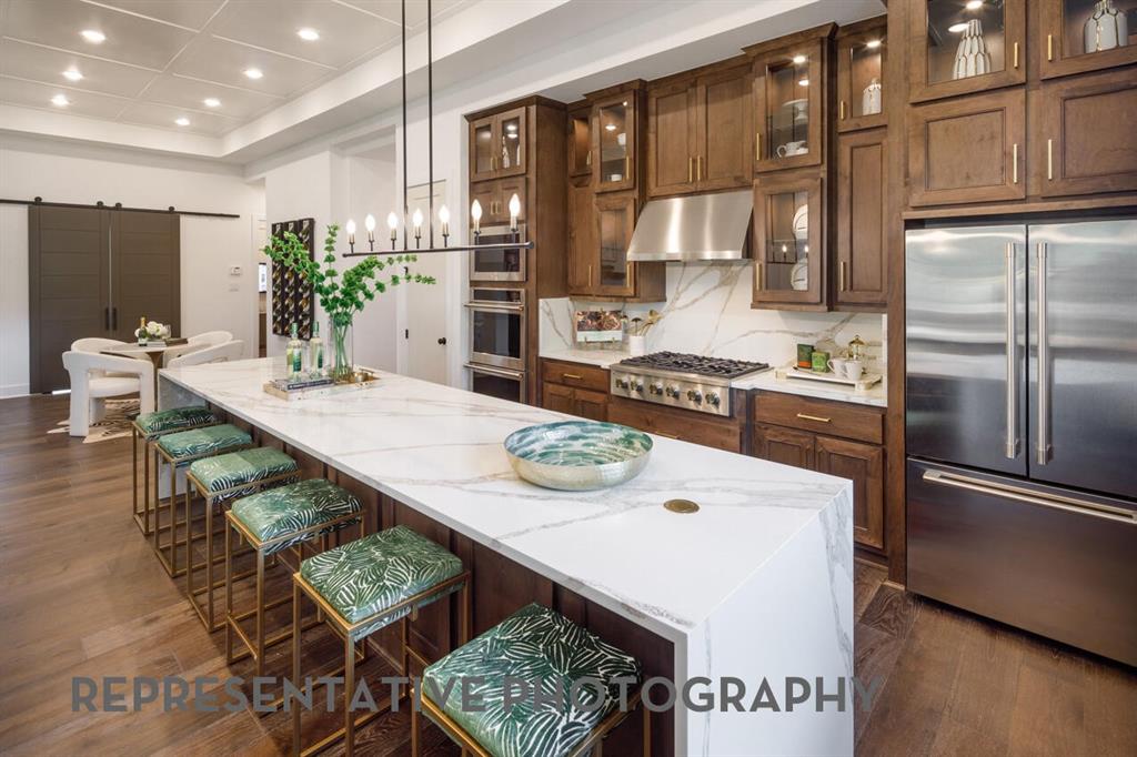 3625 Meander Way Prosper, TX 75078 - Photo 2 of 40 a kitchen with stainless steel appliances granite countertop a sink refrigerator and cabinets