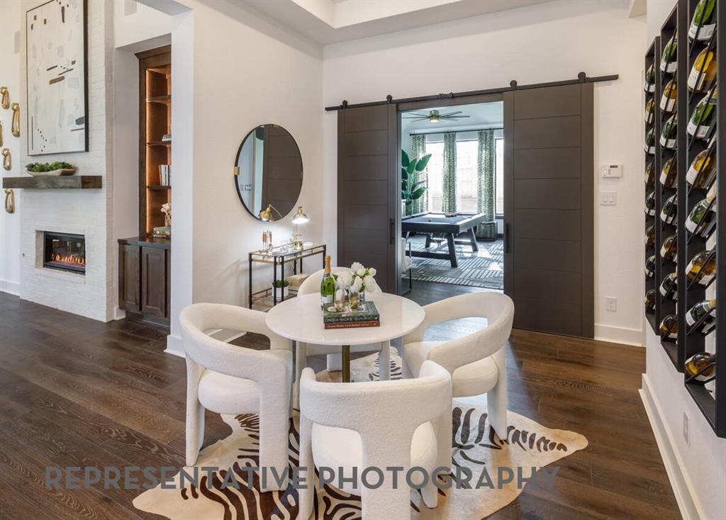 3625 Meander Way Prosper, TX 75078 - Photo 29 of 40 a living room with furniture a window and a dining table with wooden floor