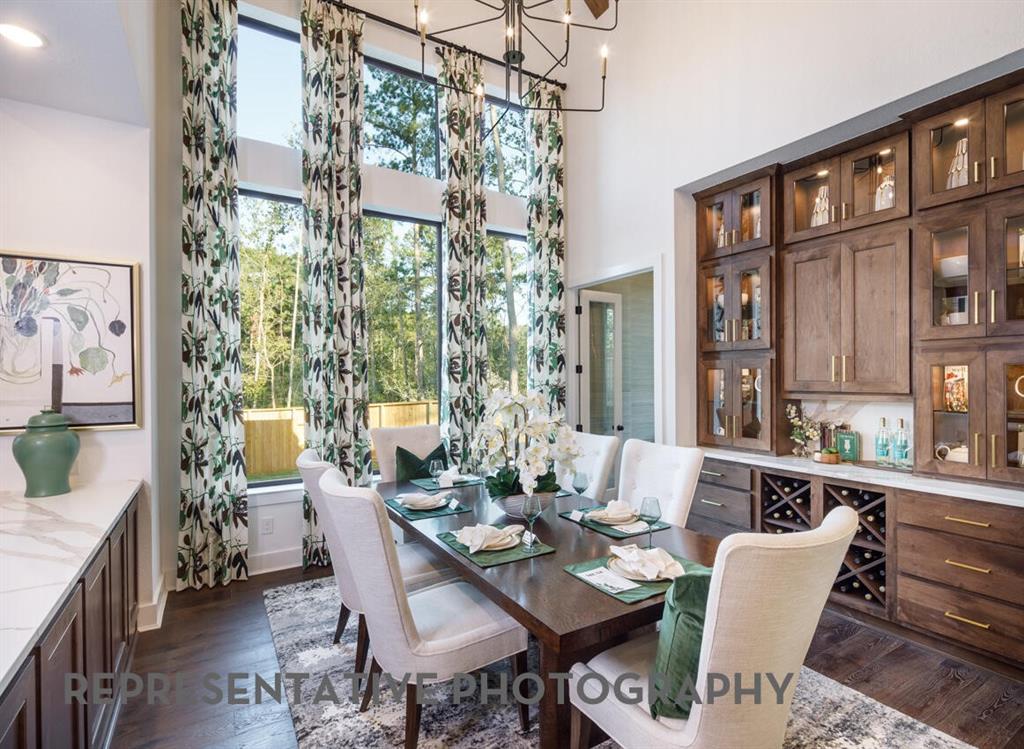 3625 Meander Way Prosper, TX 75078 - Photo 32 of 40 a view of a dining room with furniture a chandelier and wooden floor