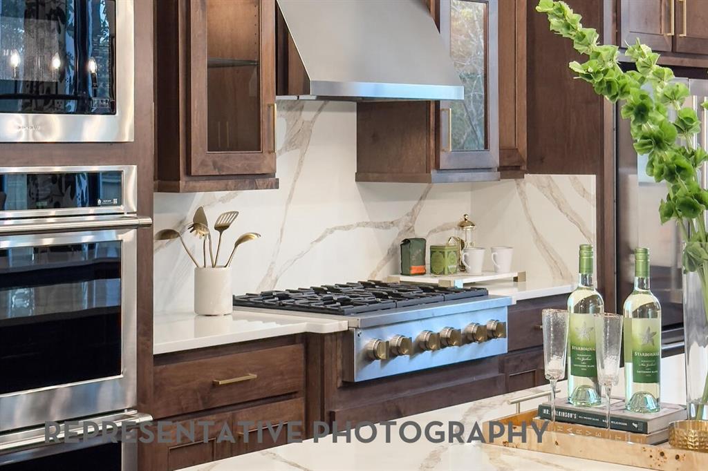 3625 Meander Way Prosper, TX 75078 - Photo 6 of 40 a kitchen with stainless steel appliances granite countertop a stove and a microwave