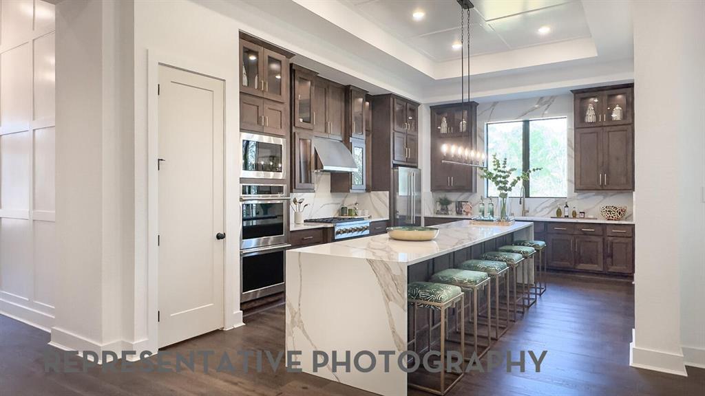 3625 Meander Way Prosper, TX 75078 - Photo 9 of 40 a kitchen with stainless steel appliances a sink and a refrigerator
