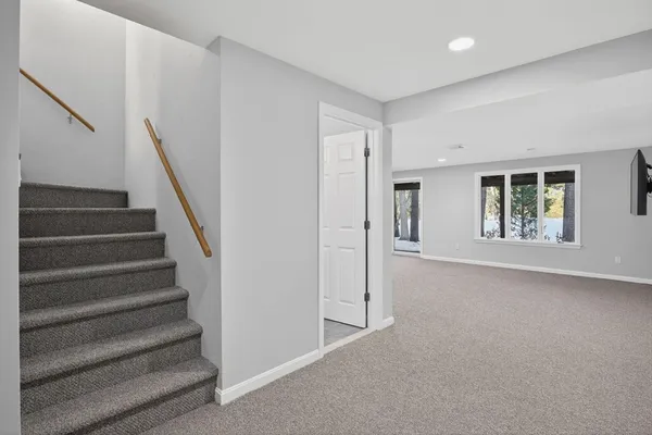 a view of an empty room with stairs and ventilation