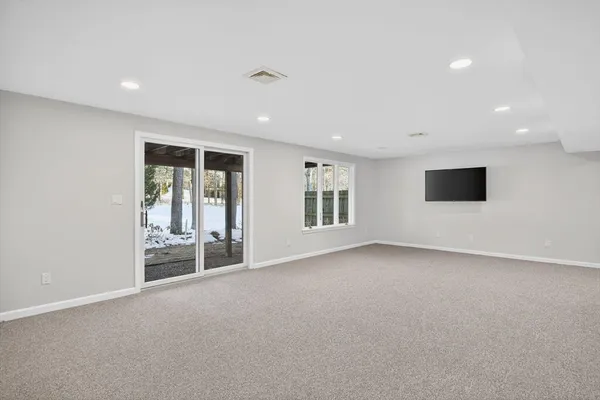 a view of a livingroom with an empty space and a window