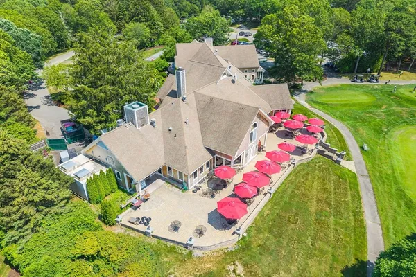 an aerial view of a house with swimming pool and yard