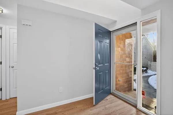 a bedroom with a bed couch and a large window