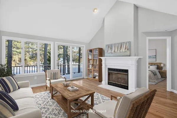 a living room with furniture a large window and a fireplace