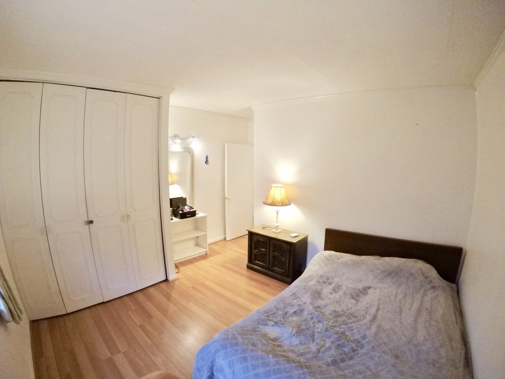 210 Lake Shore Road, Unit 3 Boston, MA 02135 - Photo 11 of 20 a bedroom with a bed and wooden floor