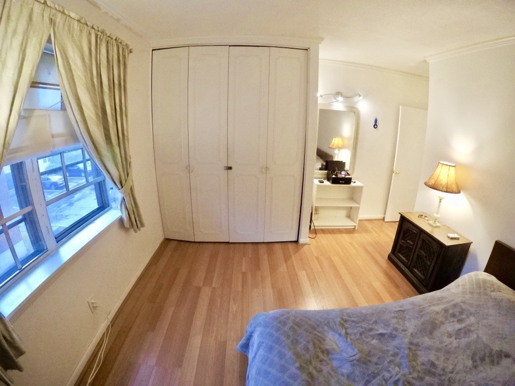 210 Lake Shore Road, Unit 3 Boston, MA 02135 - Photo 12 of 20 a bedroom with a bed and wooden floor