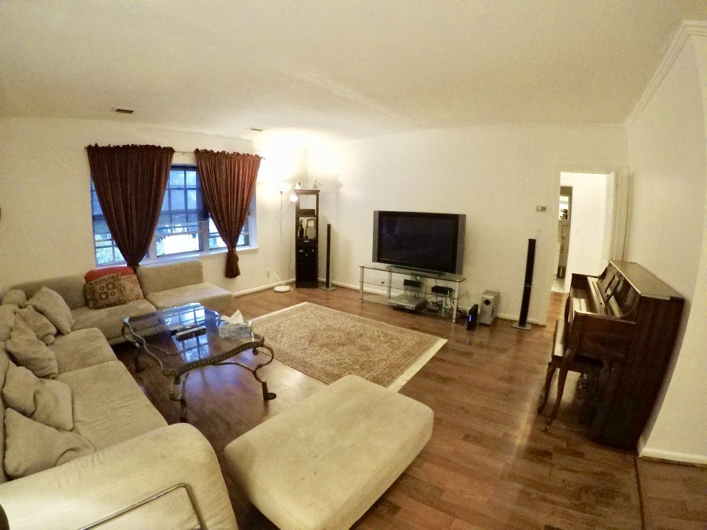 210 Lake Shore Road, Unit 3 Boston, MA 02135 - Photo 2 of 20 a living room with furniture and a flat screen tv