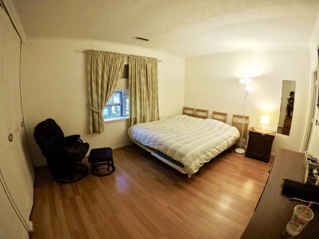 210 Lake Shore Road, Unit 3 Boston, MA 02135 - Photo 7 of 20 a bedroom with a bed and wooden floor