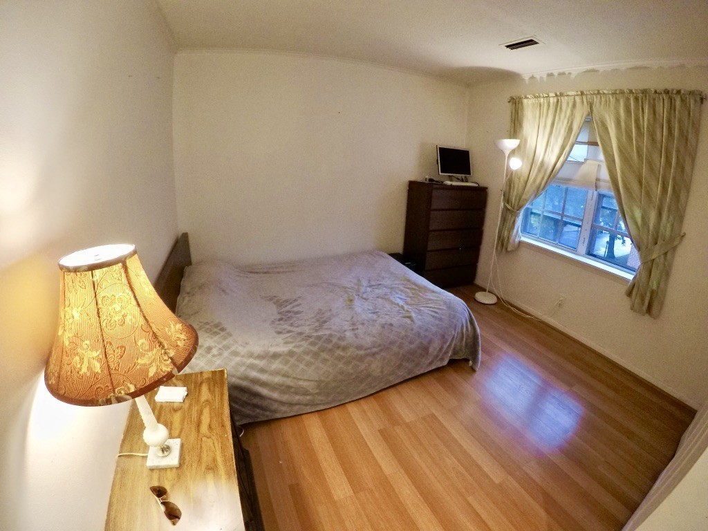 210 Lake Shore Road, Unit 3 Boston, MA 02135 - Photo 10 of 20 a bedroom with a bed and wooden floor