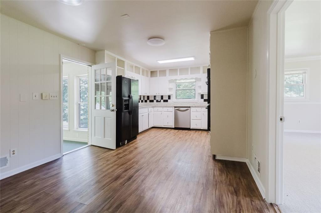 11433 Panhandle Road Hampton, GA 30228 - Photo 13 of 22 a view of a kitchen with a refrigerator and a stove top oven