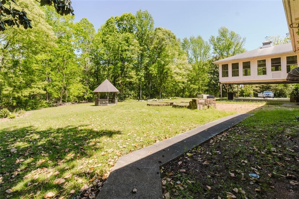11433 Panhandle Road Hampton, GA 30228 - Photo 20 of 22 a view of swimming pool with lawn chairs and plants