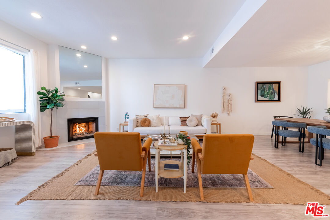839 Larrabee Street, Unit 6 West Hollywood, CA 90069 - Photo 1 of 34 a living room with furniture a fireplace and a table