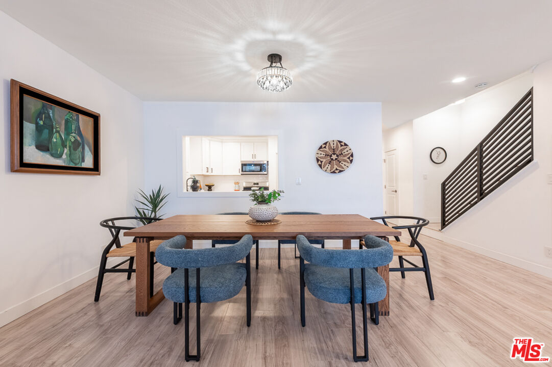 839 Larrabee Street, Unit 6 West Hollywood, CA 90069 - Photo 15 of 34 a view of a dining room with furniture and wooden floor