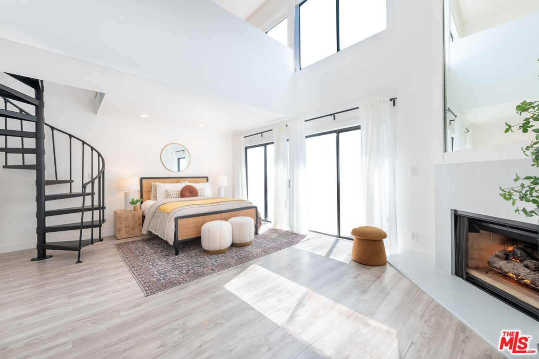 839 Larrabee Street, Unit 6 West Hollywood, CA 90069 - Photo 24 of 34 a bedroom with a bed and a fireplace