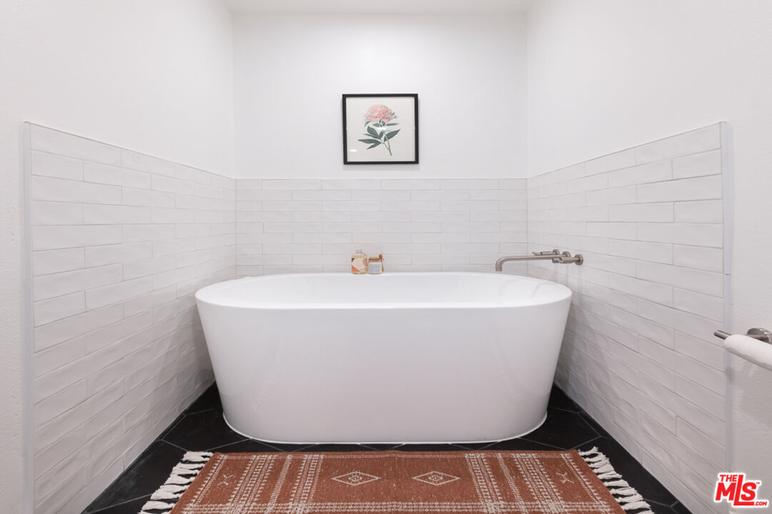 839 Larrabee Street, Unit 6 West Hollywood, CA 90069 - Photo 30 of 34 a white bath tub sitting in a bathroom