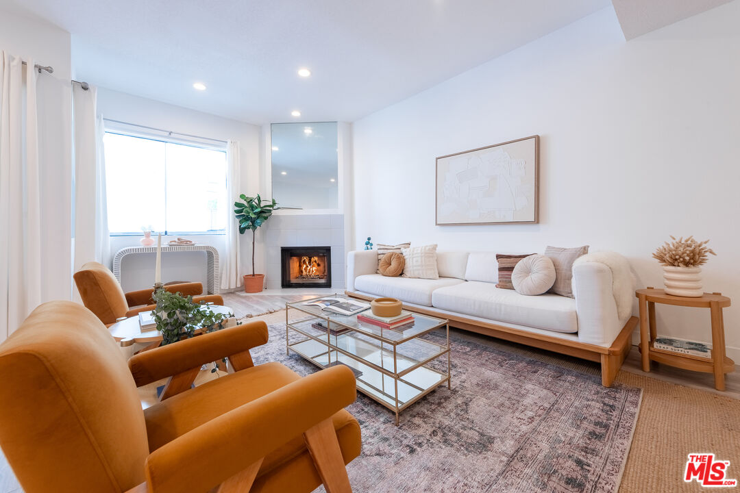 839 Larrabee Street, Unit 6 West Hollywood, CA 90069 - Photo 7 of 34 a living room with furniture and a fireplace