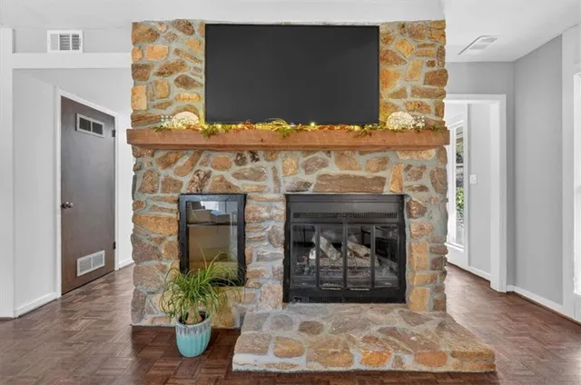 a view of living room with furniture and a fireplace