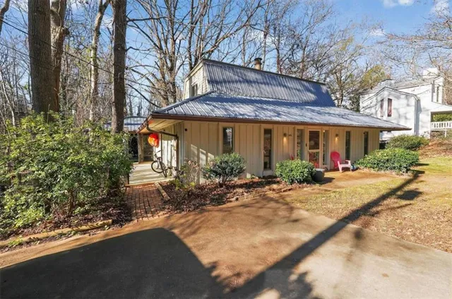 a view of a house with backyard and sitting area