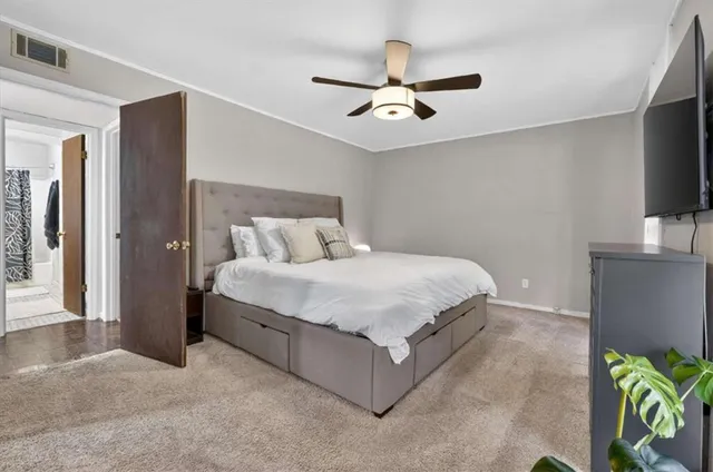 a bedroom with a bed and a flat screen tv