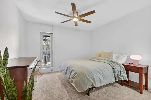 a bedroom with a bed and a window