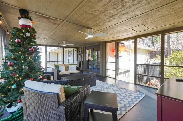 a living room with furniture and a potted plant
