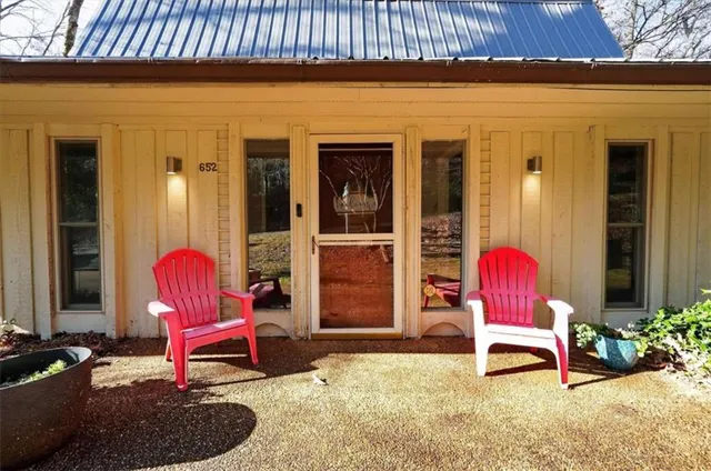 a chair and table in front of a house