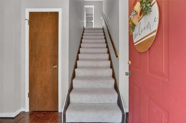 a view of staircase with wooden floor and entryway