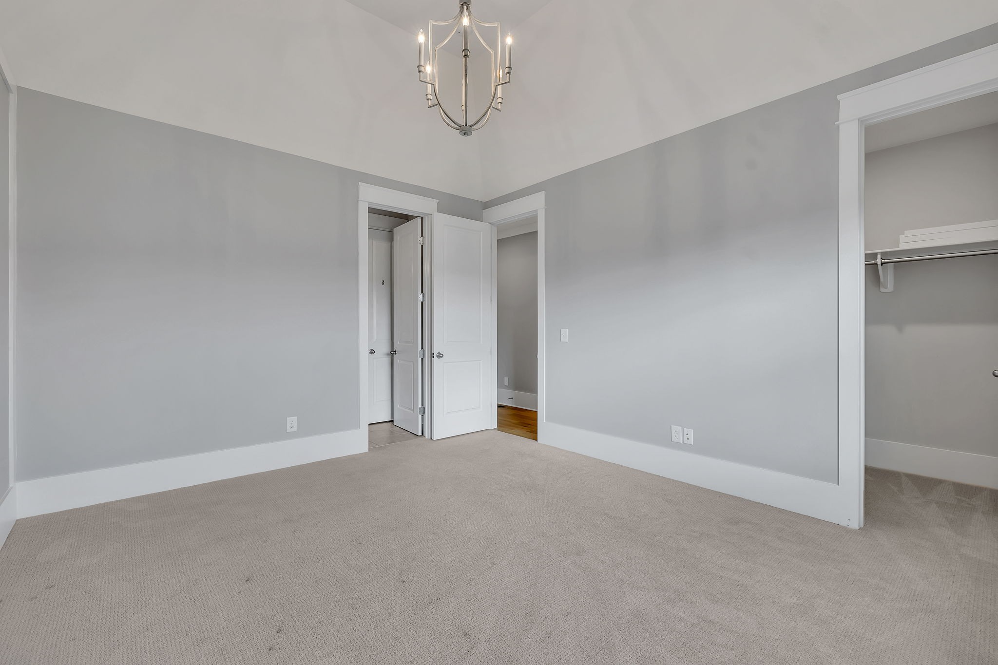 5821 Wagonvale Drive Arrington, TN 37014 - Photo 46 of 69 an empty room with a chandelier fan and wooden floor