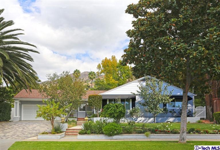 225 West Kenneth Road Glendale, CA 91202 - Photo 1 of 31 a front view of a house with a garden and trees