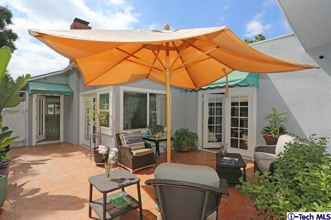 225 West Kenneth Road Glendale, CA 91202 - Photo 11 of 31 a patio with a table and chairs under an umbrella