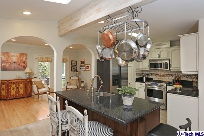 225 West Kenneth Road Glendale, CA 91202 - Photo 15 of 31 a kitchen with stainless steel appliances granite countertop a dining table chairs and granite counter tops