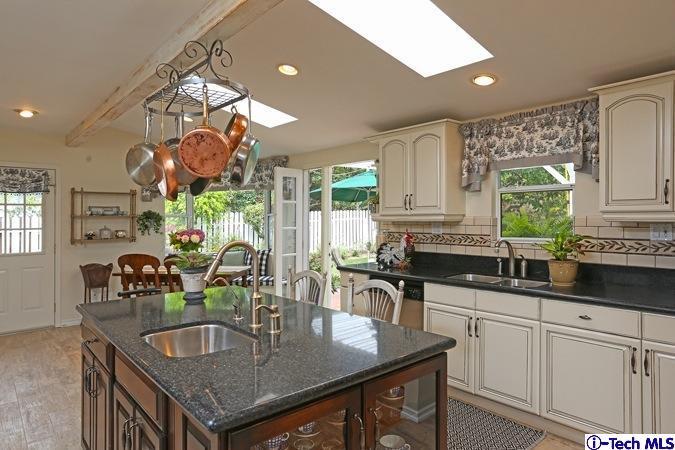 225 West Kenneth Road Glendale, CA 91202 - Photo 16 of 31 a kitchen with a table chairs and cabinets