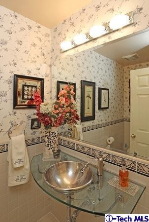 225 West Kenneth Road Glendale, CA 91202 - Photo 21 of 31 a bathroom with a sink mirror and vanity