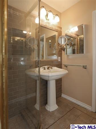 225 West Kenneth Road Glendale, CA 91202 - Photo 26 of 31 a bathroom with a sink mirror and shower