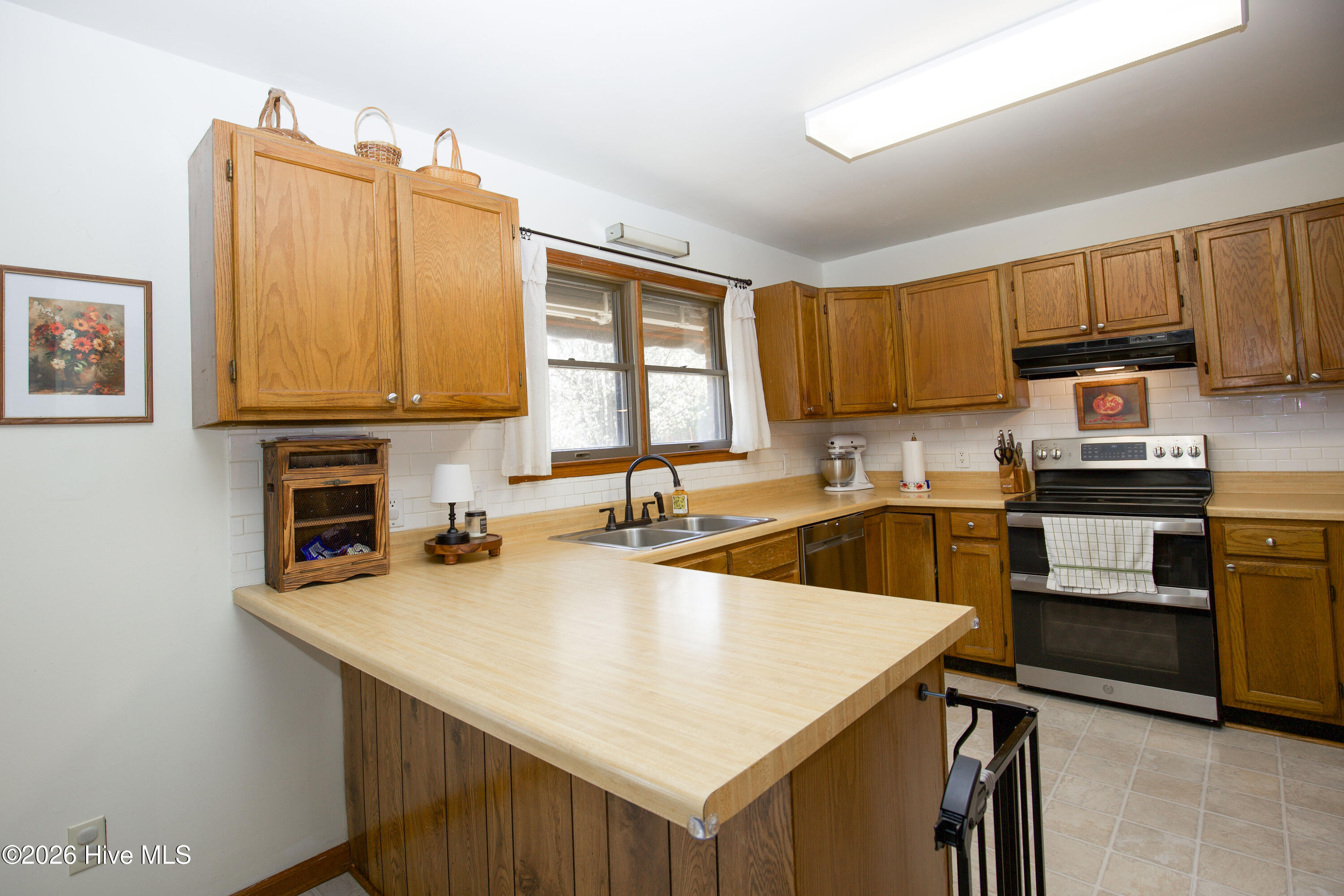 124 Joseph Road Aberdeen, NC 28315 - Photo 10 of 59 Kitchen featuring central workspace and ample cabinetry, offering practical layout for everyday use.
