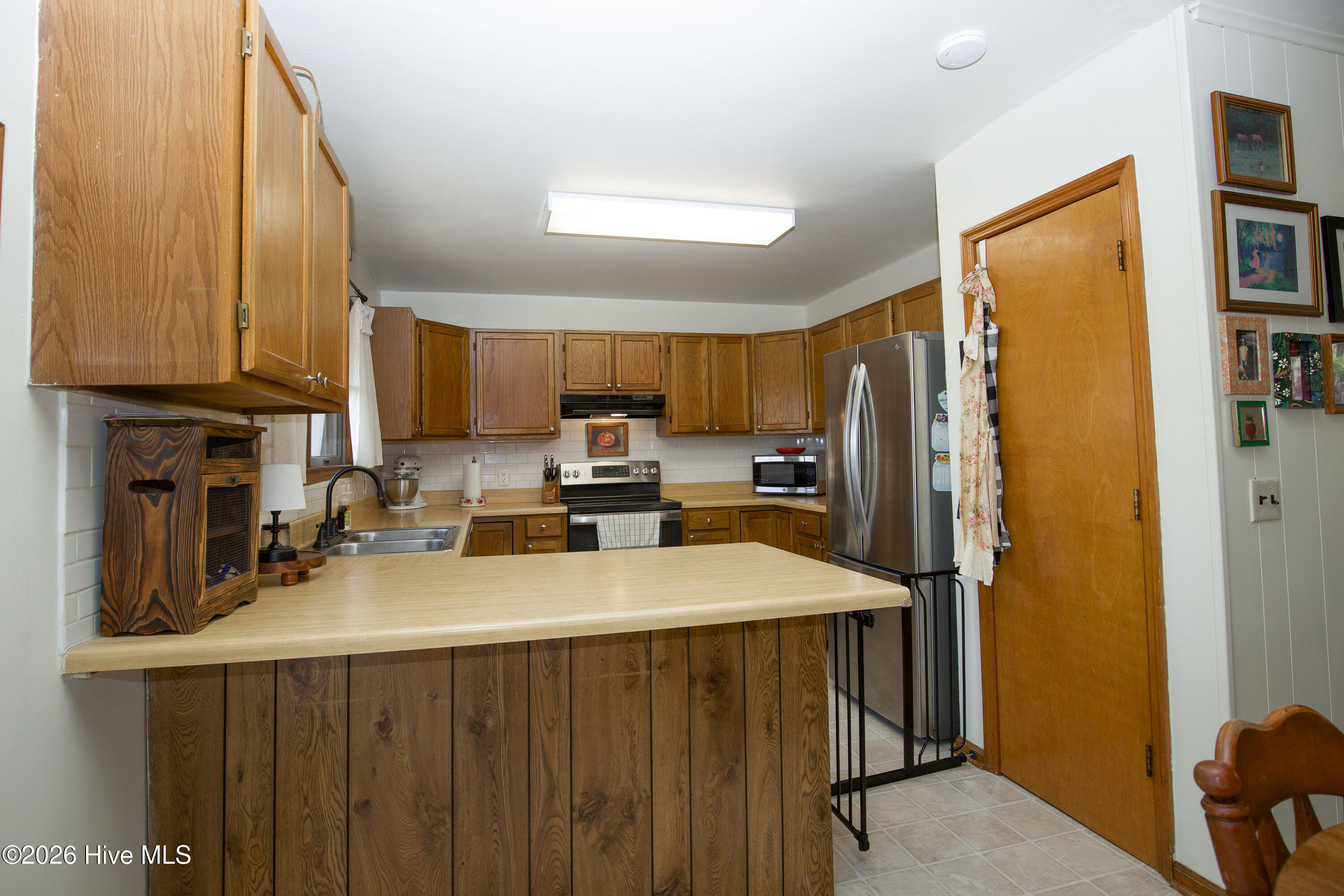 124 Joseph Road Aberdeen, NC 28315 - Photo 13 of 59 Kitchen view toward entry and adjoining spaces, showing flow to dining and living areas.