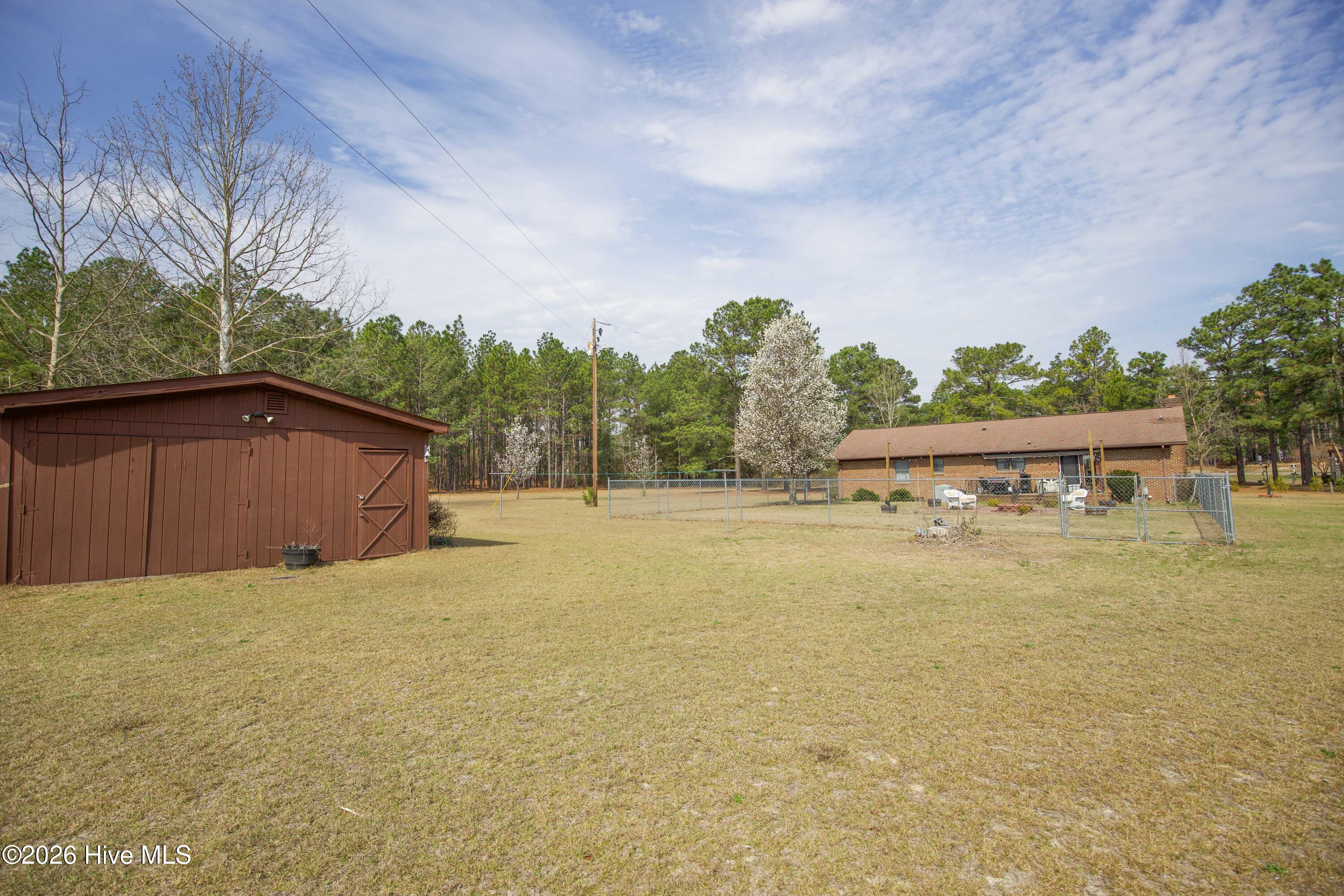 124 Joseph Road Aberdeen, NC 28315 - Photo 39 of 59 View of the detached powered workshop located on the property at 124 Joseph Road. The workshop provides dedicated space for tools, hobbies, equipment storage, or project work. Situated on approximately 5.06 acres, the property offers plenty of room to spread out while enjoying the privacy of a rural Moore County setting with convenient access to Aberdeen, Southern Pines, Pinehurst, and commuting routes to Fort Bragg and Camp Mackall.