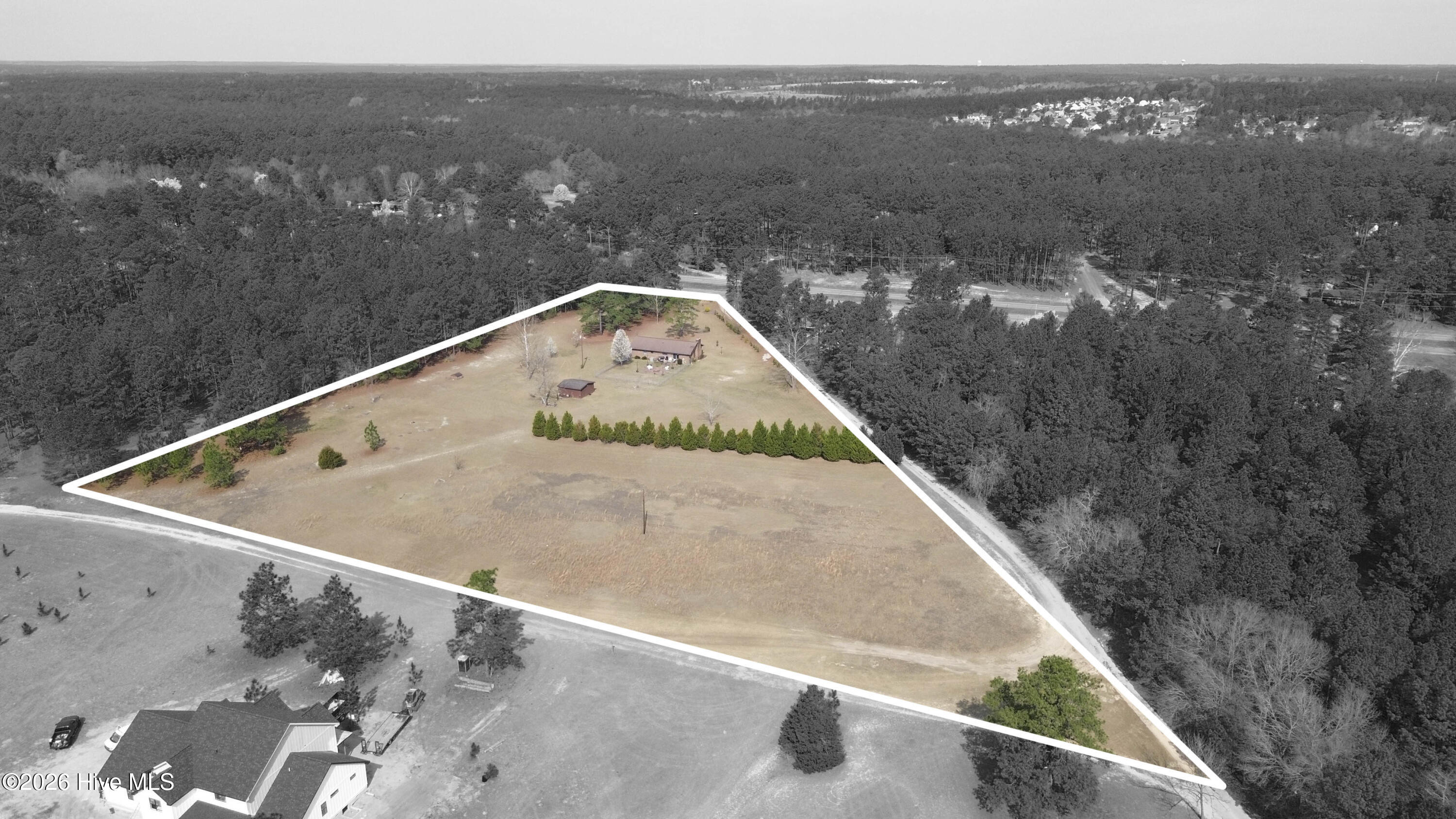 124 Joseph Road Aberdeen, NC 28315 - Photo 4 of 64 Aerial view of 124 Joseph Road oriented toward the rear of the property, showing the home, yard, and surrounding acreage. The property consists of two adjoining parcels totaling approximately 5.06 acres in Moore County. Parcel ID 00055747 (2.18 acres) contains the residence and is being sold together with adjoining Parcel ID 00055745 (2.88 acres). The land features a combination of open space and mature trees, offering room for gardening, recreation, or additional outbuildings. Boundary lines shown are approximate and provided for illustration purposes only. Buyers should consult the recorded plat or a licensed survey to verify exact property boundaries.