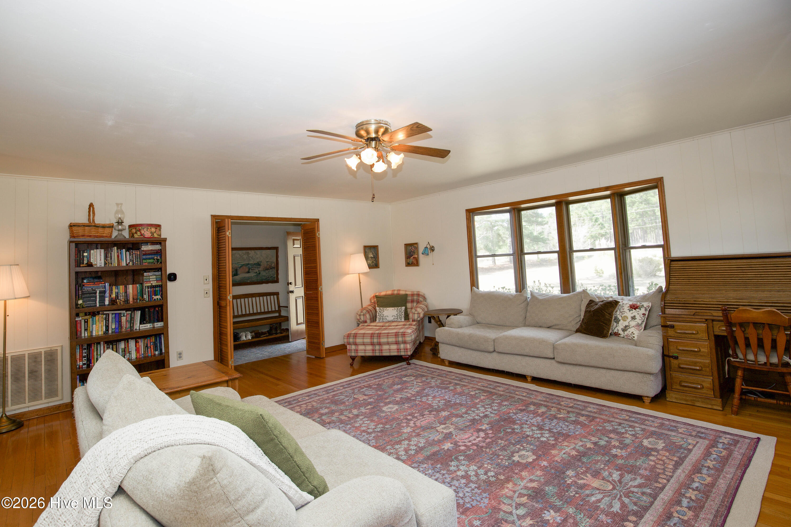 124 Joseph Road Aberdeen, NC 28315 - Photo 5 of 59 Alternate view of the living room from the side entry, highlighting natural light from front-facing windows and connection to foyer.