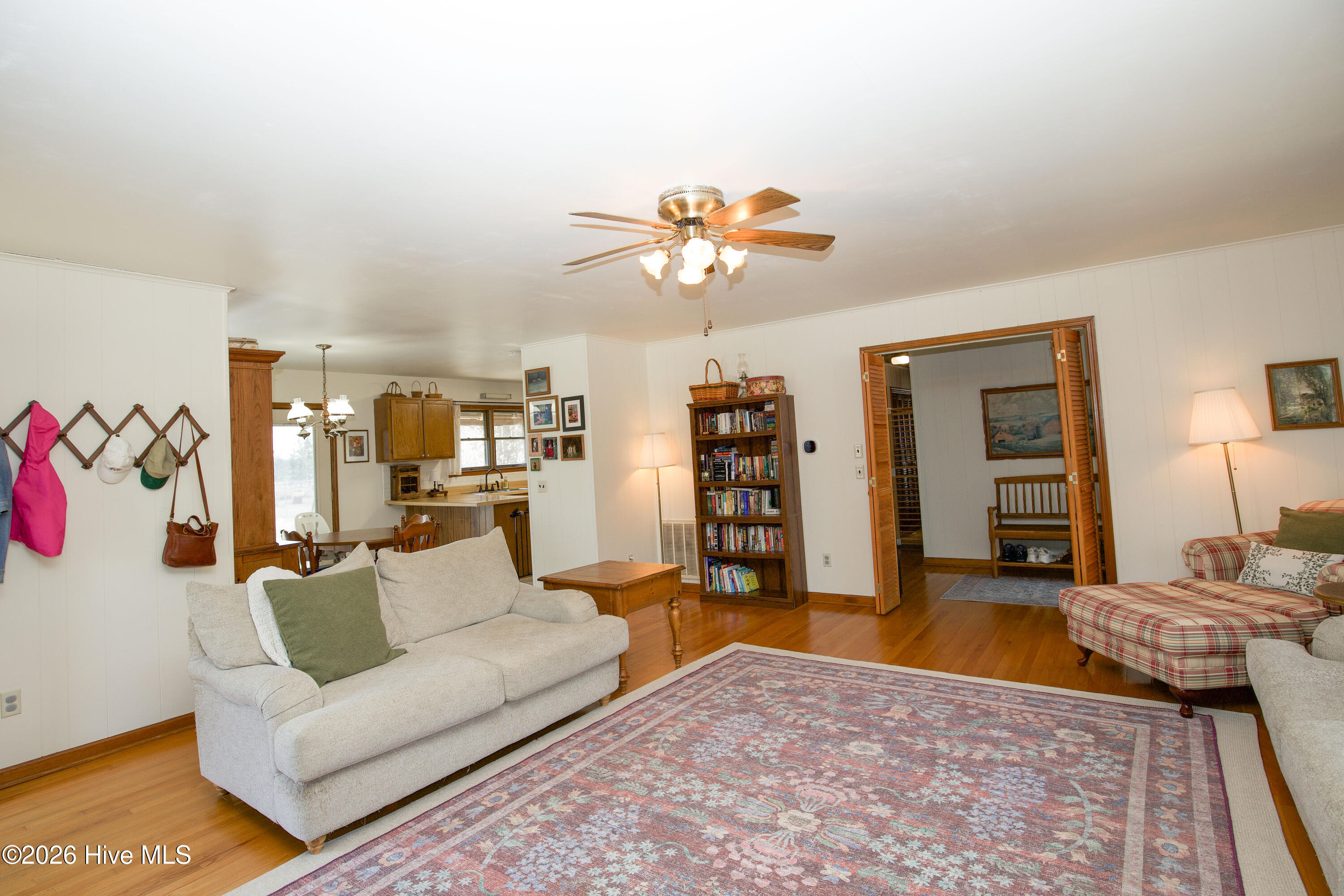 124 Joseph Road Aberdeen, NC 28315 - Photo 6 of 59 Additional living room angle showcasing seating area, hardwood floors, and flexible layout for furniture arrangement.