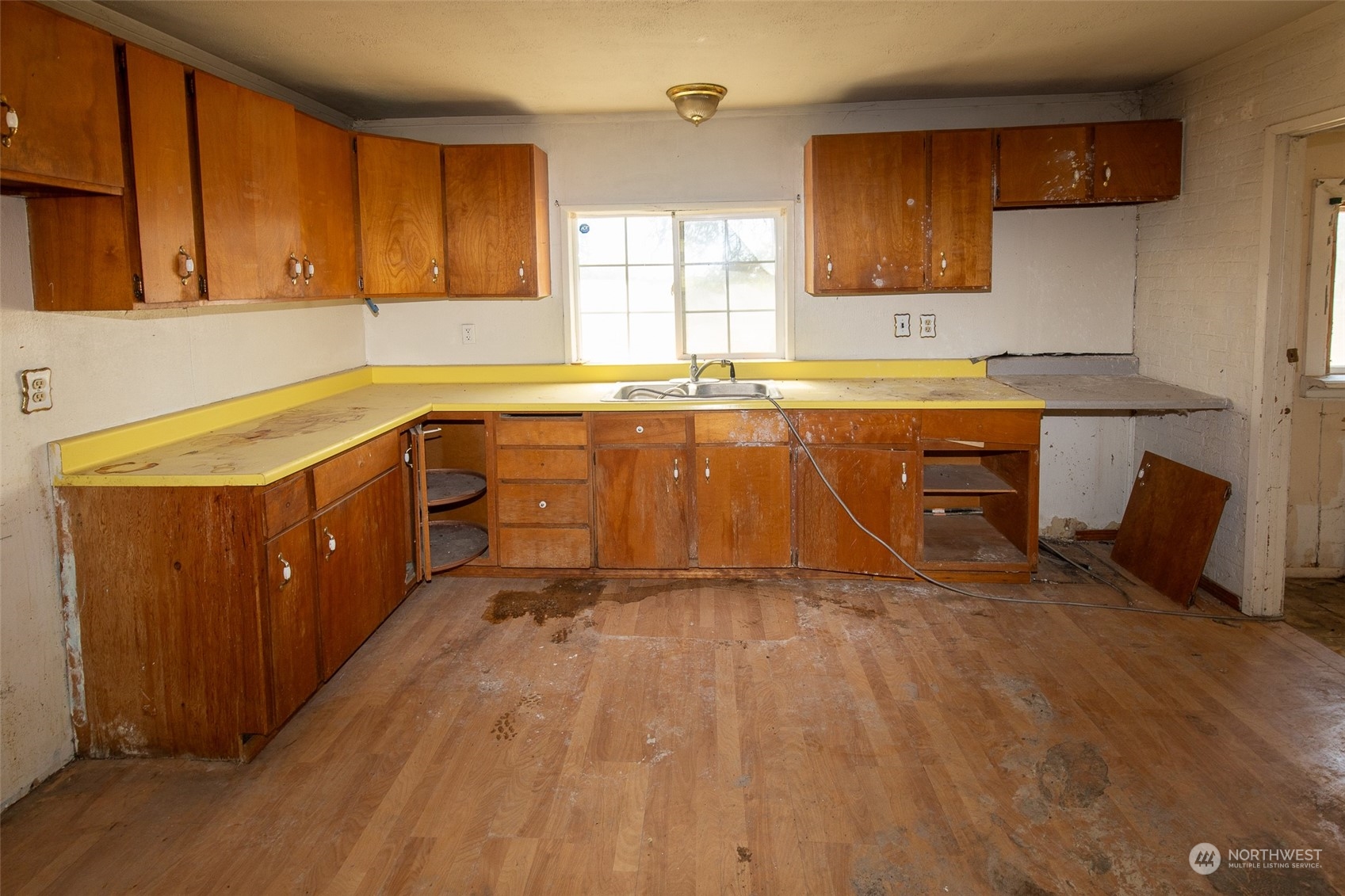 4838 Rd L.9 Northeast Moses Lake, WA 98837 - Photo 11 of 20 a large kitchen with wooden floors and a sink